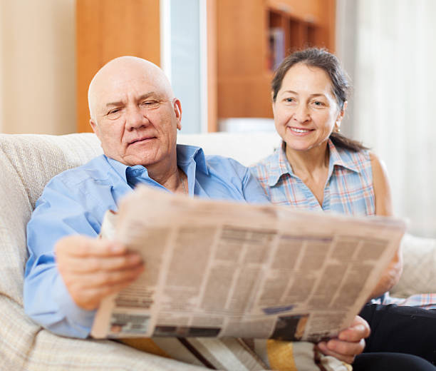 istock mature couple reading newspaper  together 531942820