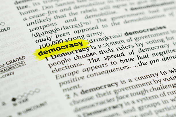 Detail of the english word "democracy" and its meaning Detail of the english word "democracy"  highlighted and its definition from the dictionary democracy stock pictures, royalty-free photos & images