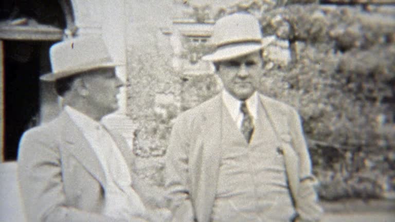 1937: Elite businessmen in formal fashion dress with fedora hats.