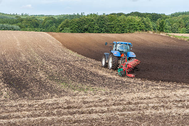 istock Farmer plowing field with tractor 531948693