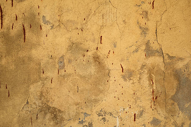 istock Texture of old wall covered with yellow stucco 531949285