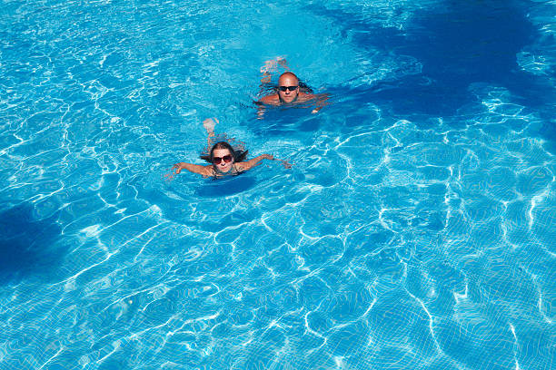 istock Couple swimming in pool 531949773