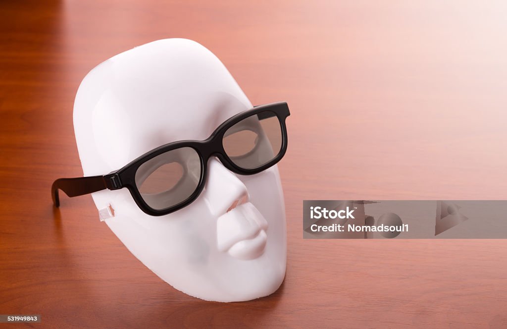 Theater mask in glasses on the table Theater mask in glasses on the wooden table 2015 Stock Photo