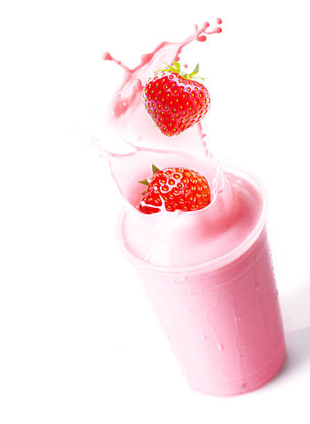 istock Ripe strawberries splashing into fruit smoothie 531949917