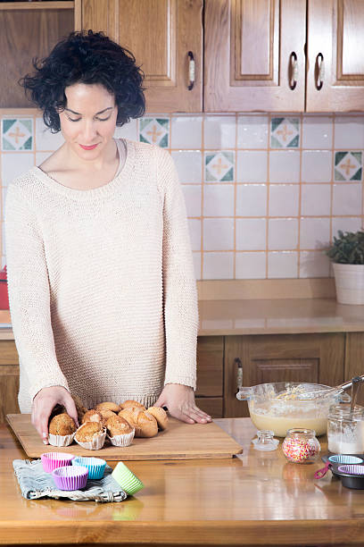 Woman picking a homemade fresh cupcake