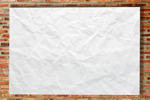 istock White crumpled paper on brick wall 531950591