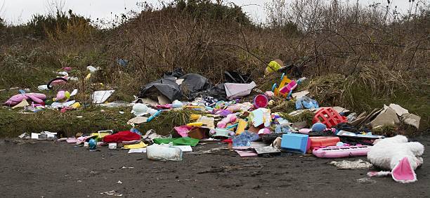 illegal dumping of rubbish by roadside stock photo