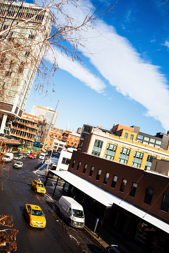 New York City, NY, USA - January 9, 2015: View of the Standard Hotel and the Meatpacking District in Chelsea. New construction going up next to the high line, left. Cabs and trucks on street. 