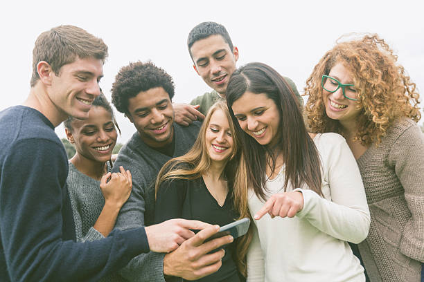 istock Multiethnic Group of Friends Looking at Mobile Phone 531954965