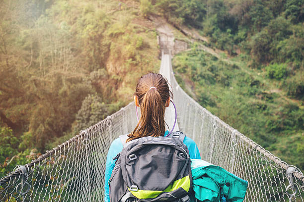 istock Hiker girl crossing footbridge 531966394