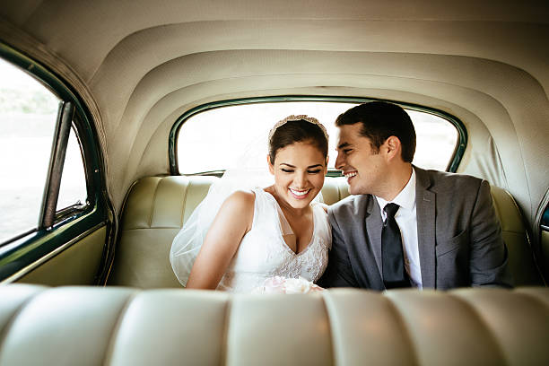 istock Beautiful Hispanic newlyweds laughing in backseat 531967272