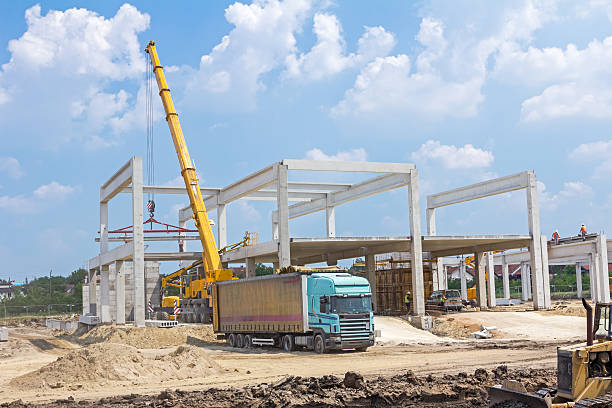 istock Mobile crane is unloading concrete joist from truck trailer. 531967516