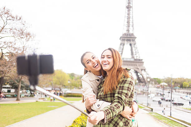 istock Smiling young women making selfie in front of Eiffel tower 531969034