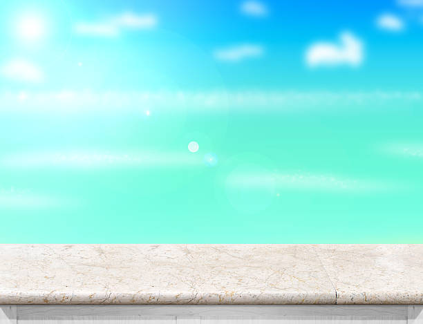 istock white marble table with blurred sea,sun and beach 531971644