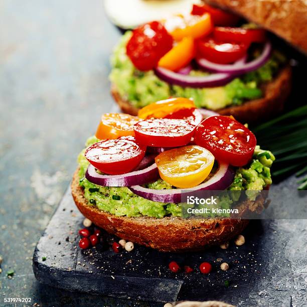 Tasty Homemade Sandwiches With Avocado Tomato Onion And Pepper Stock Photo - Download Image Now