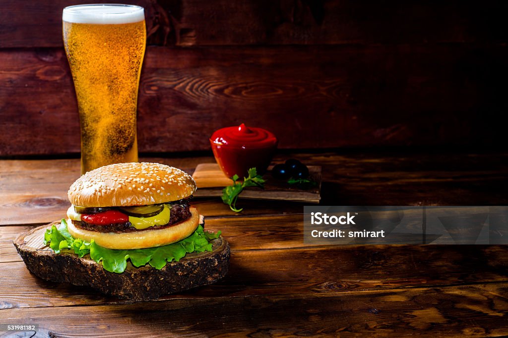 classic burger classic burger on a wooden table Alcohol - Drink Stock Photo