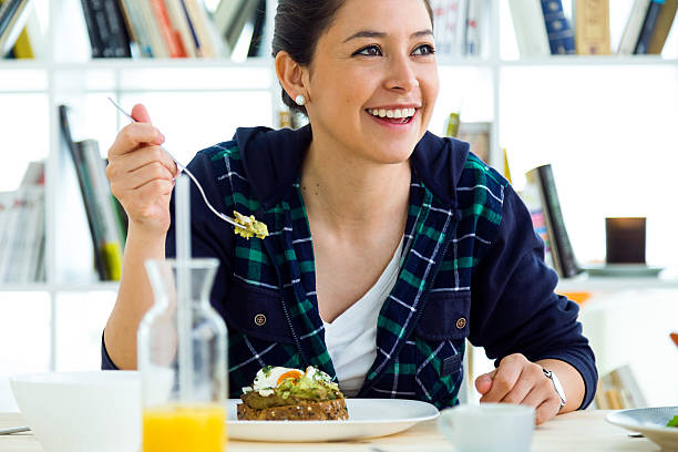 istock Beautiful young woman enjoying breakfast in the kitchen. 531982010