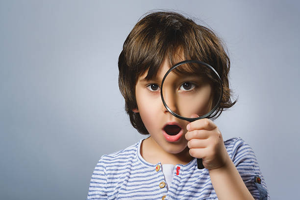 Child See Through Magnifying Glass, Kid Eye Looking with Magnifier stock photo