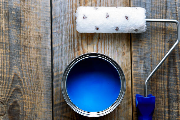 istock painting with  can of blue paint and roller top view 531982854