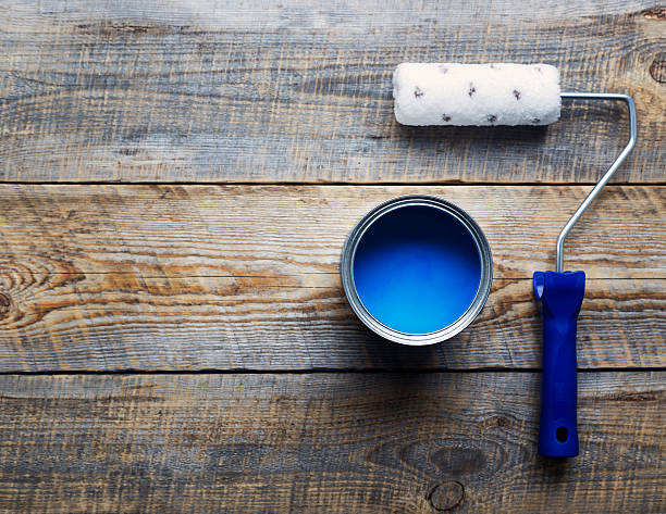 istock painting with  can of blue paint and roller top view 531983070