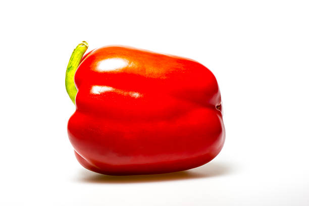 Red bell pepper on dark wood background