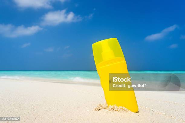 Sunscreen Cream Bottle On The Beach Stock Photo - Download Image Now - Beach, Suntan Lotion, Bottle