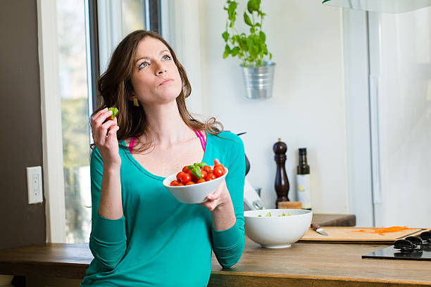 istock Young woman eating a cherry tomatoes 531985200