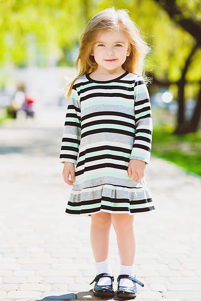 istock happy blond little girl posing at park 531986648