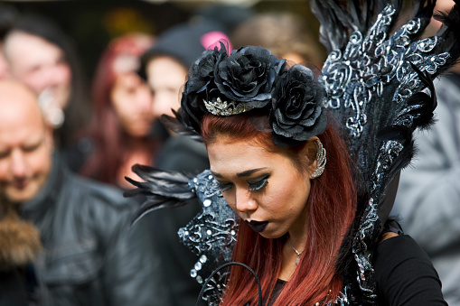 Leipzig, Germany - May 14, 2015: Young woman clad in a fantasy costume. Visitors of the annual Wave Gothic Meeting in Leipzig. Every year on Pentecost thousands of fans of the gothic subculture are celebrating one of the biggest music and cultural festivals of its kind worldwide. Everybody tries to dress up more sexy or curious than everyone else. The shot has been taken on the AGRA fairgrounds.