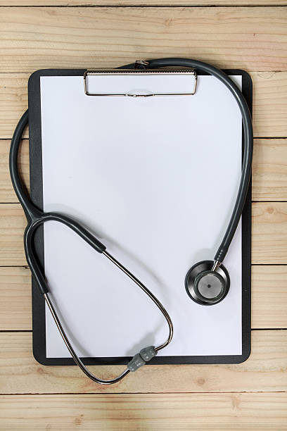 istock clipboard with stethoscope and syringe on wooden background 531987499