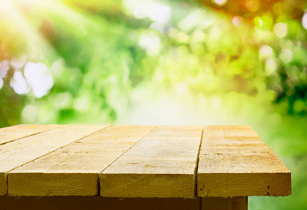 istock Empty wooden table with garden bokeh 531989221