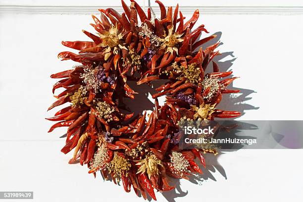 Santa Fe Style Red Chili Pepper Wreath On White Door Stock Photo - Download Image Now