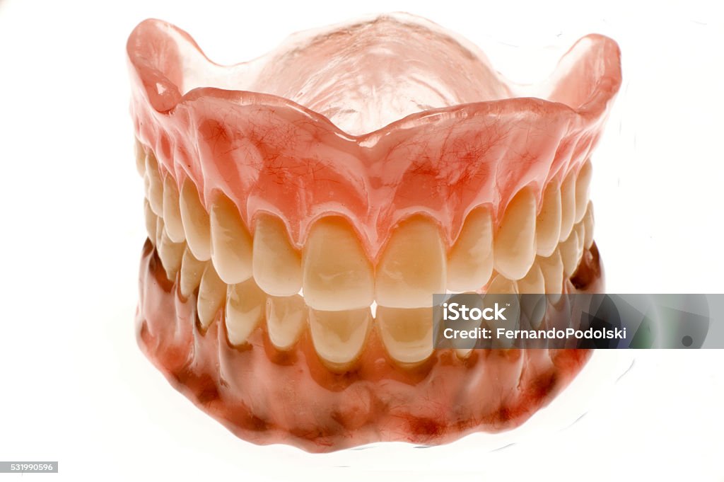 Dental Prosthesis Closeup of a complete denture on white background Close-up Stock Photo