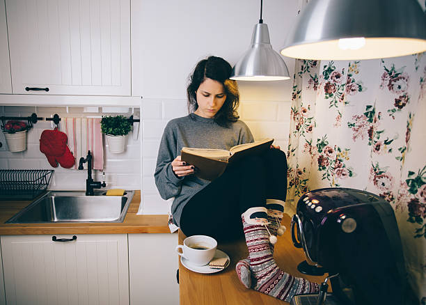 istock Girl reading a book at home 531990869