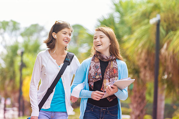 istock Cute young teens walking to school bus stop together 531990909