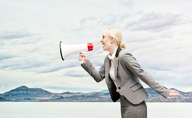 istock Cheerful businesswoman shouting with megaphone 531990969