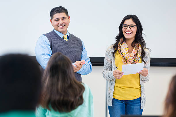 istock College student reading report with teacher to class 531990995