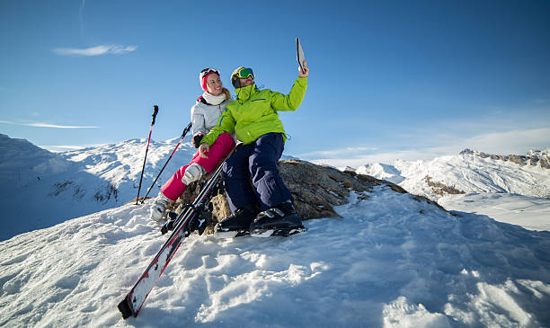 istock Couple taking selfie with digital tablet on ski slopes 531991037