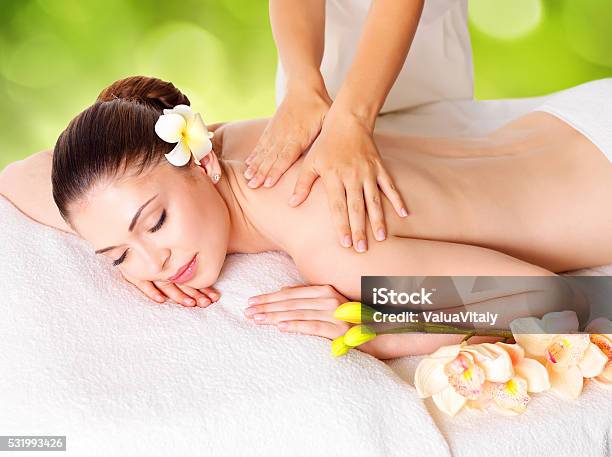 Woman Having Massage Of Body In Nature Spa Stock Photo - Download Image Now - Adult, Alternative Therapy, Beautician