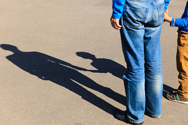 istock Shadows of father and son holding hands 531993978