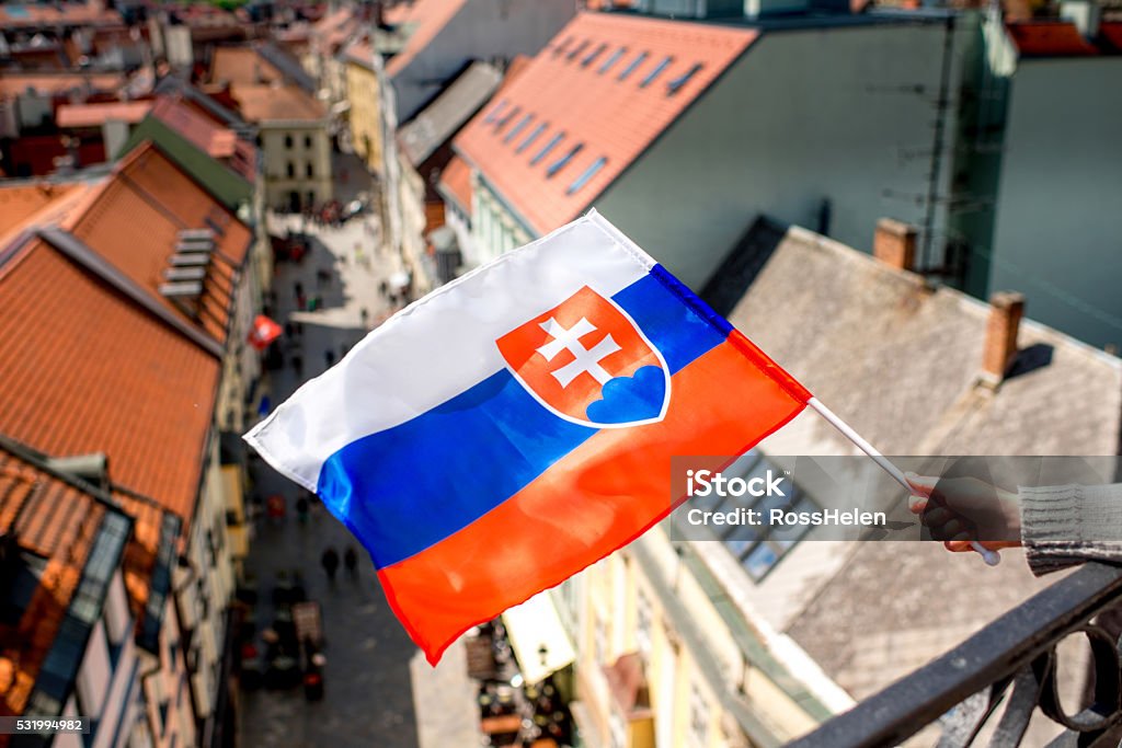 Slovak flag on Bratislava city background Slovak flag on the old town background in Bratislava the capital of Slovakia Architecture Stock Photo