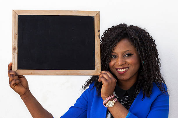 istock young african american girl shows a blackboard 531995502