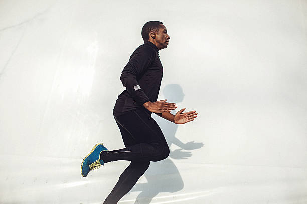 istock Young fit man running beside the white wall 531995994