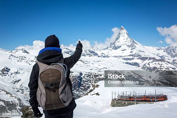 Woman Hiker With Backpack Poiting At Matterhorn Stock Photo - Download Image Now - Nature, One Person, People