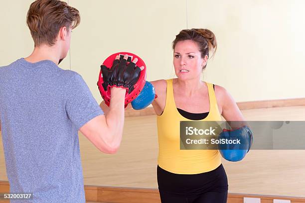Female Kick Boxer With Trainer In Sparring Stock Photo - Download Image Now - 2015, 30-39 Years, Active Lifestyle