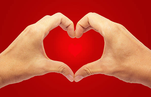 istock Valentines - Making Heart with 2 Hands on Red Background 532004039