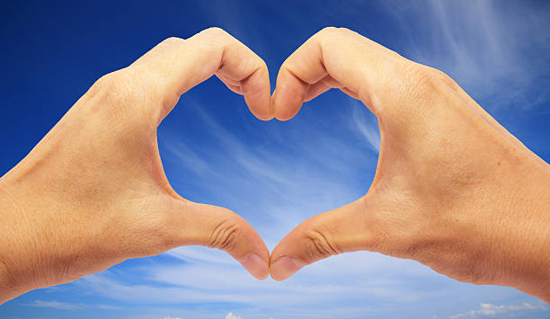 istock Valentines - Making Heart with 2 Hands on Blue Sky 532004053
