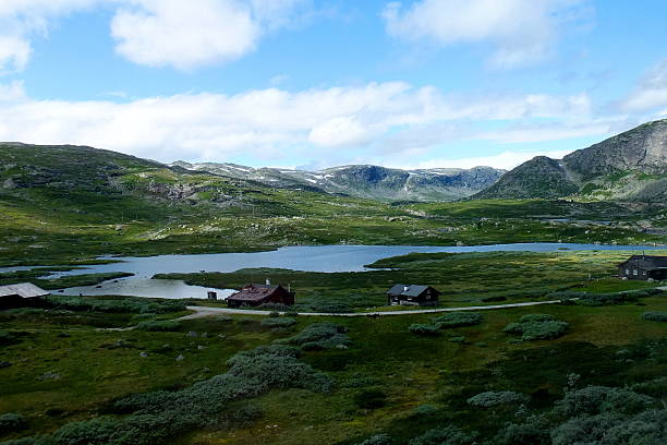 istock Norwegian lake and mountain scenery with small wooden huts 532004795