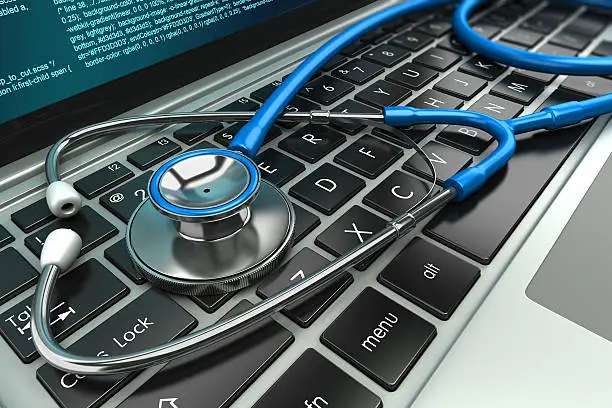 Photo of Stethoscope on laptop keyboard. Concept