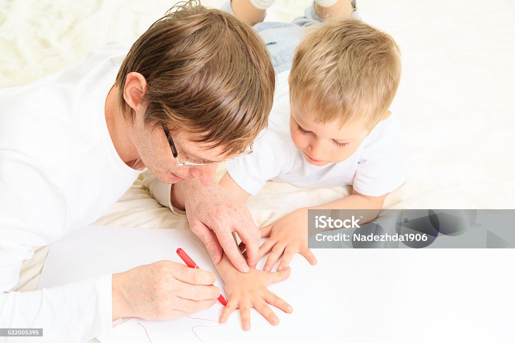 father outdrawing child hand father outdrawing child hand, sweet memories 2015 Stock Photo